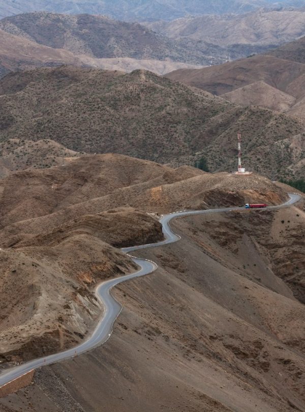 brown mountains with gray road during daytime